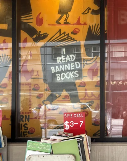A bookshop window with a banned-books poster