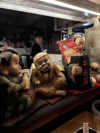 A shelf of small seated figurines