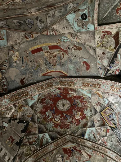 An ornate mosaic ceiling in teal and red