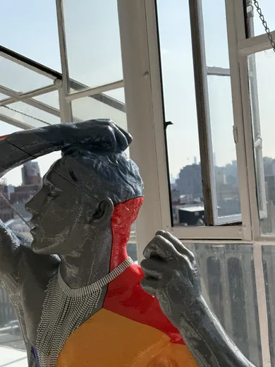 A statue by a bright window