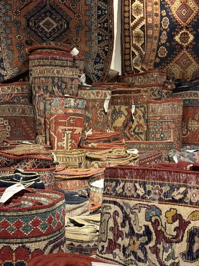 Stacks of patterned rugs in a shop