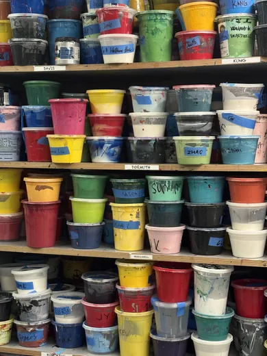 Shelves of colourful paint tubs
