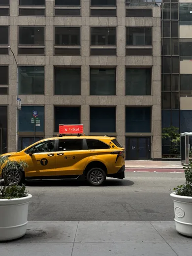 A yellow taxi on a city street
