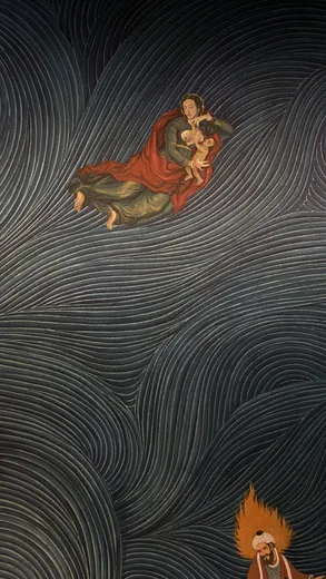 A detail of a swirling dark mural with a figure in red