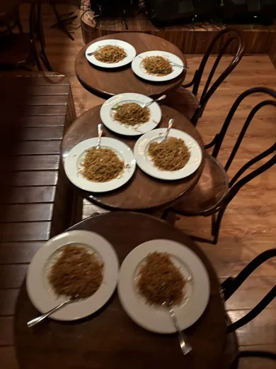 Plates of noodles on bistro tables
